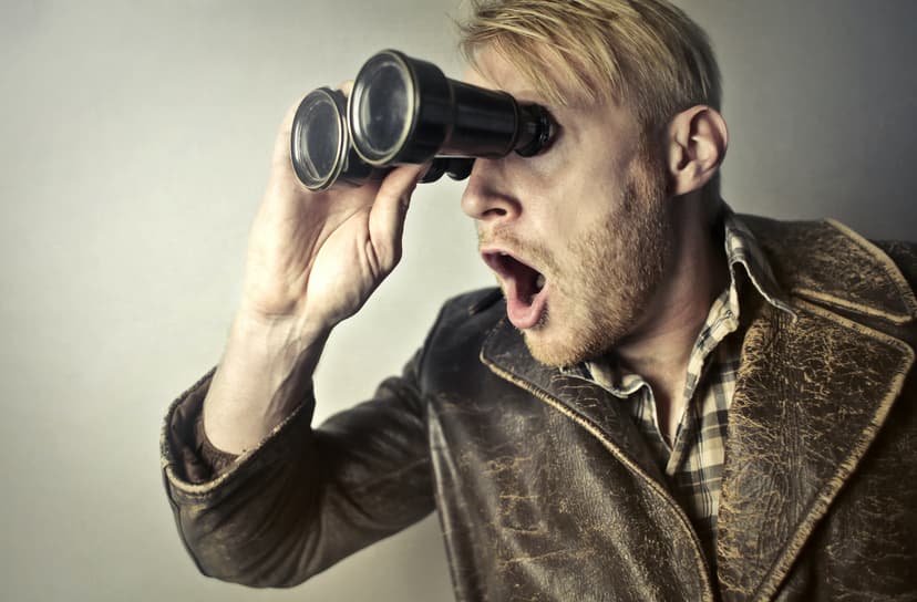 Man looking through binoculars